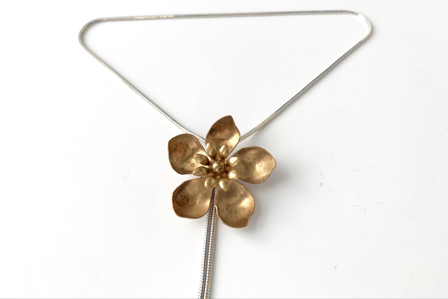 Close up detail of the WILD ROSE Flower Bolo Tie necklace by Lord Violet, shown against a white background.