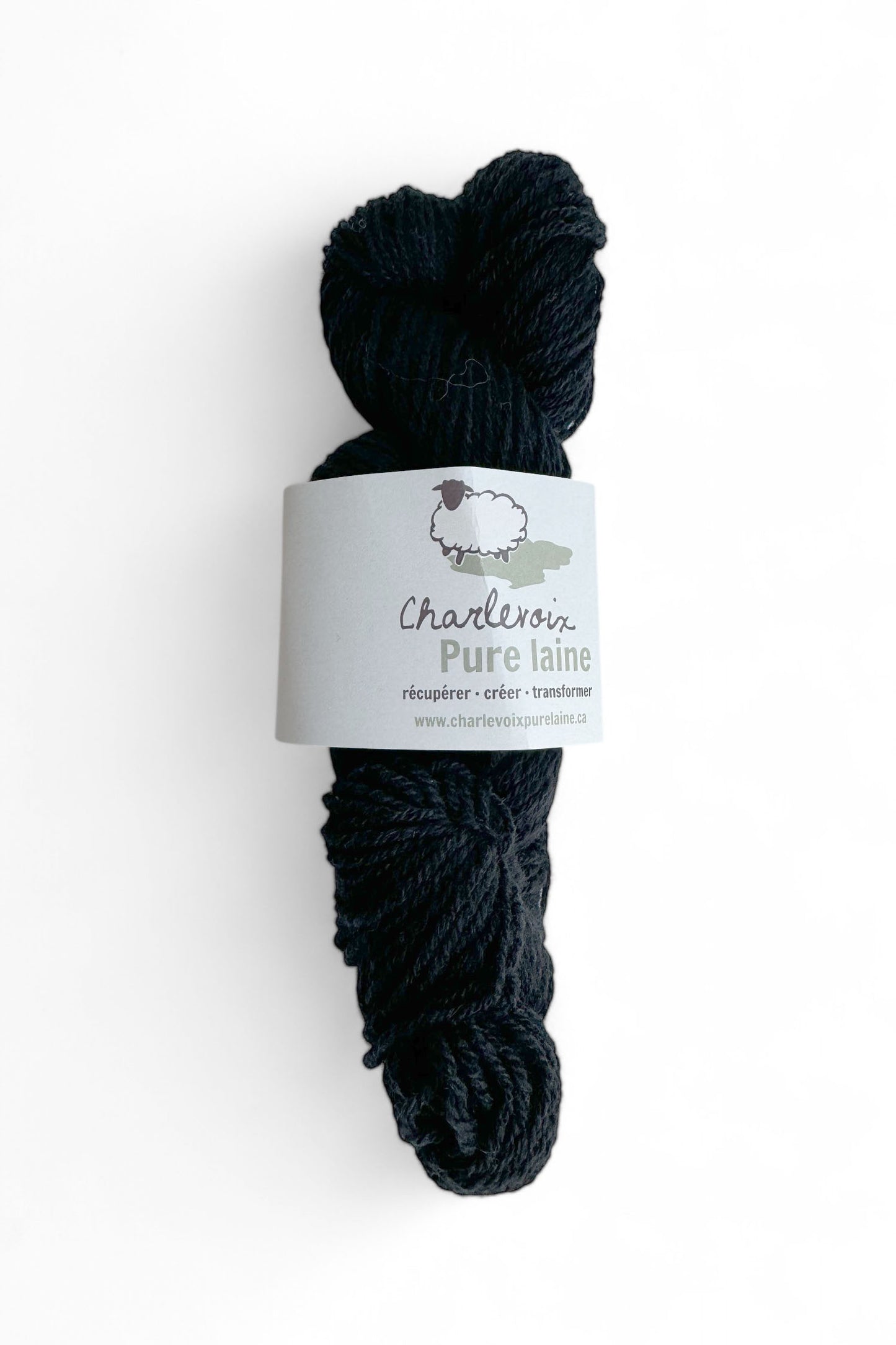 A skein of Black yarn from Charlevoix Pure Laine is shown against a white background