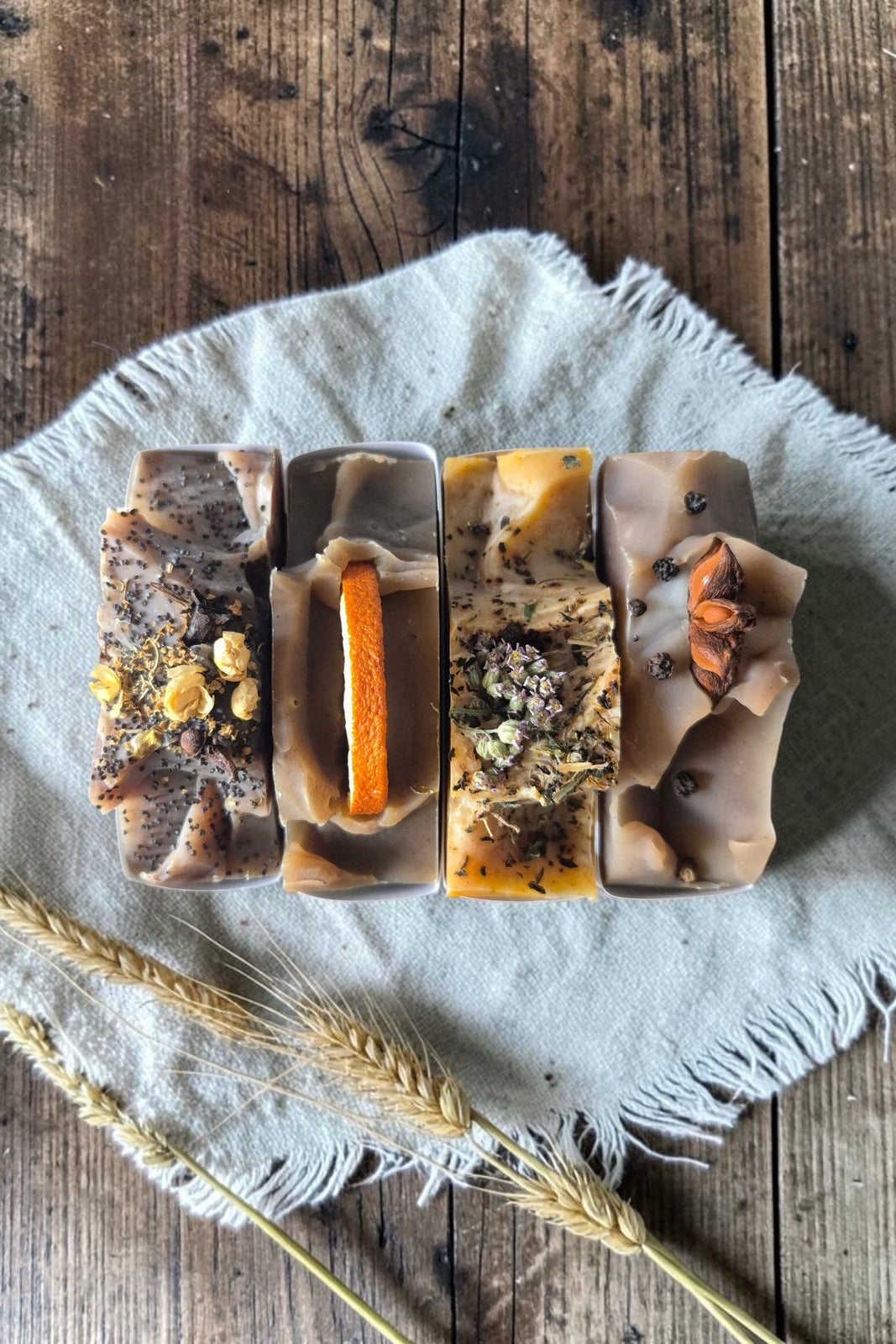 Overhead view of bars of Stay Wild Apothecary soap on a wooden table