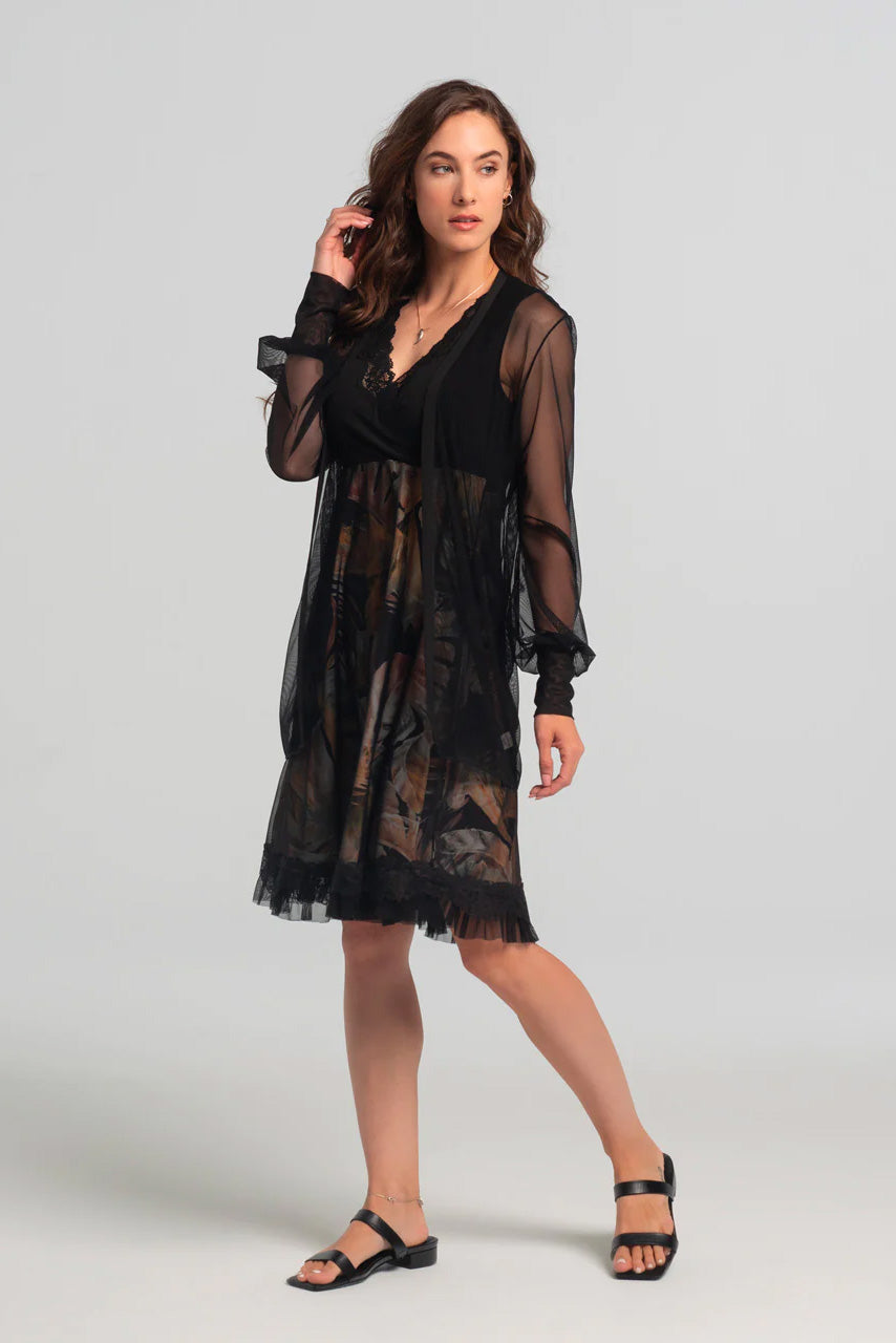Levana Dress by Kollontai, black top with wrap-over neckline and lace trim, sleeveless, empire waist, A-line skirt with tropical print under a black mesh layer, ruffled hem, knee length, sizes XS to XXL, made in Quebec