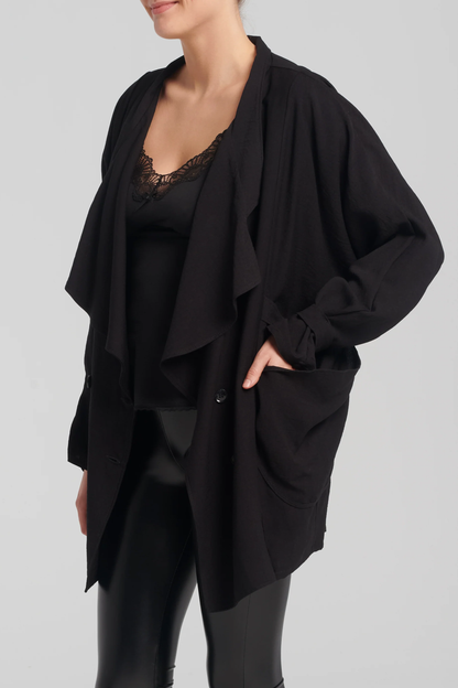 Coventina Jacket by Kollonai, Black, oversized, large ruffled collar, double breasted, patch pockets, cinched cuffs, sizes S-L, made in Montreal 