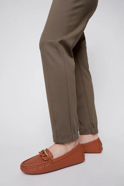 Close up lower leg view of a woman wearing the Sarah Cigarette Pant by Julei in Fern, featuring four way stretch fabric, pin tucks for shape, and a pull-on waist. 