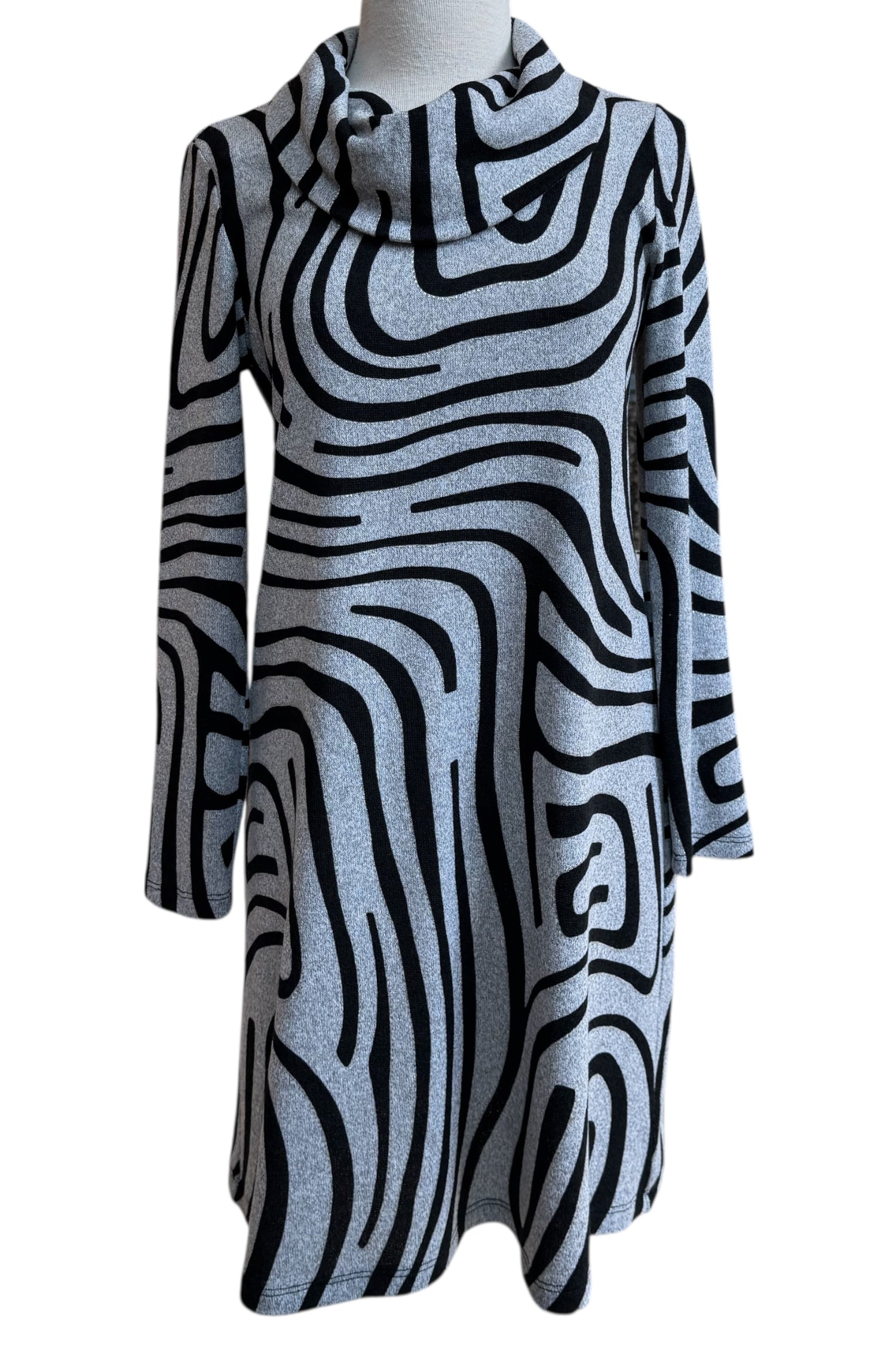 The Powell Dress by Compli K in Black and Silver Swirl, featuring a cowl neck, long sleeves, and a slight trapeze shape, is shown in front of a white background. 
