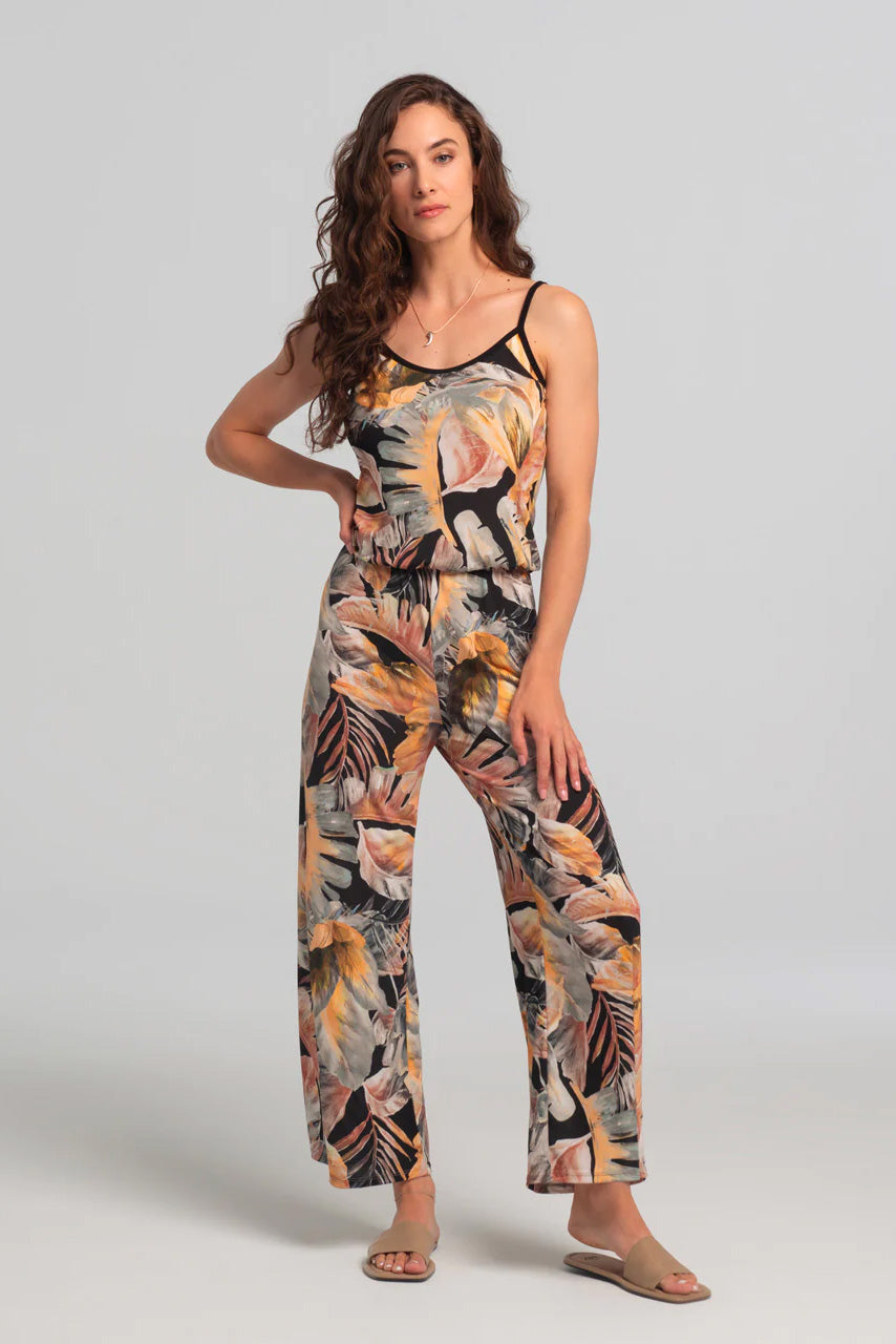 Nephele Jumpsuit by Kollontai, neutral toned tropical print, black piping at neckline and  spaghetti straps, bloused effect at waist, sizes XS to XL, made in Quebec