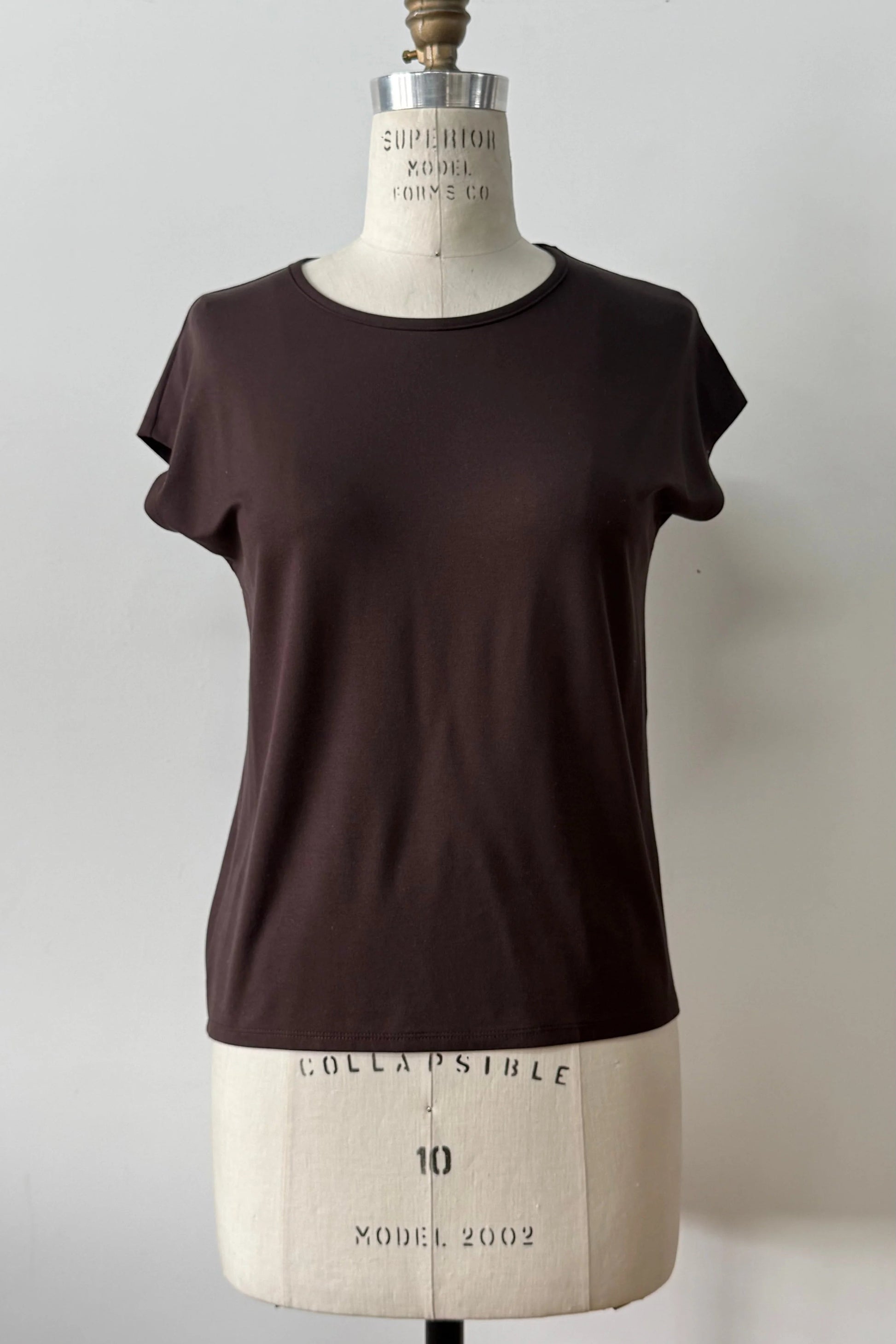 The Eowyn T-Shirt by Kollontai in Chocolate is shown on a white mannequin against a white 