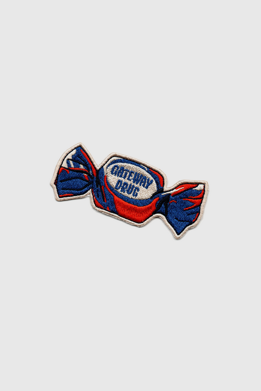 Embroidered Badaboöm Studio patch of a candy with 'Gateway Drug' text on a white background
