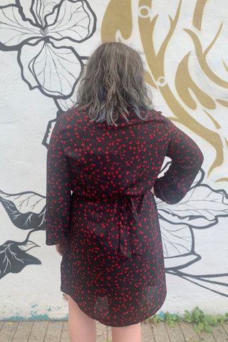 Rosehip Dress by Compli K, Red Floral, back view, black slip dress underlayer, sheer floral overlay, V-neck with placket, long sleeves with gathers at wrists, rounded hem, sizes XS to XXL, made in Canada
