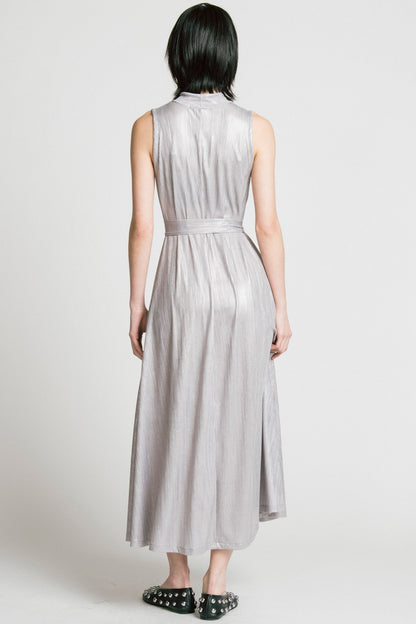 Back view of a woman wearing the Swing Dress by Allison Wonderland in Silver, a sleeveless mock neck maxi dress in shimmery fabric. 