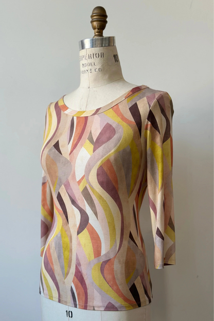The Vellina Top from Kollontai in Peach print, a 3/4 sleeve fitted top with a wide neck, is shown on a mannequin against a white background. 