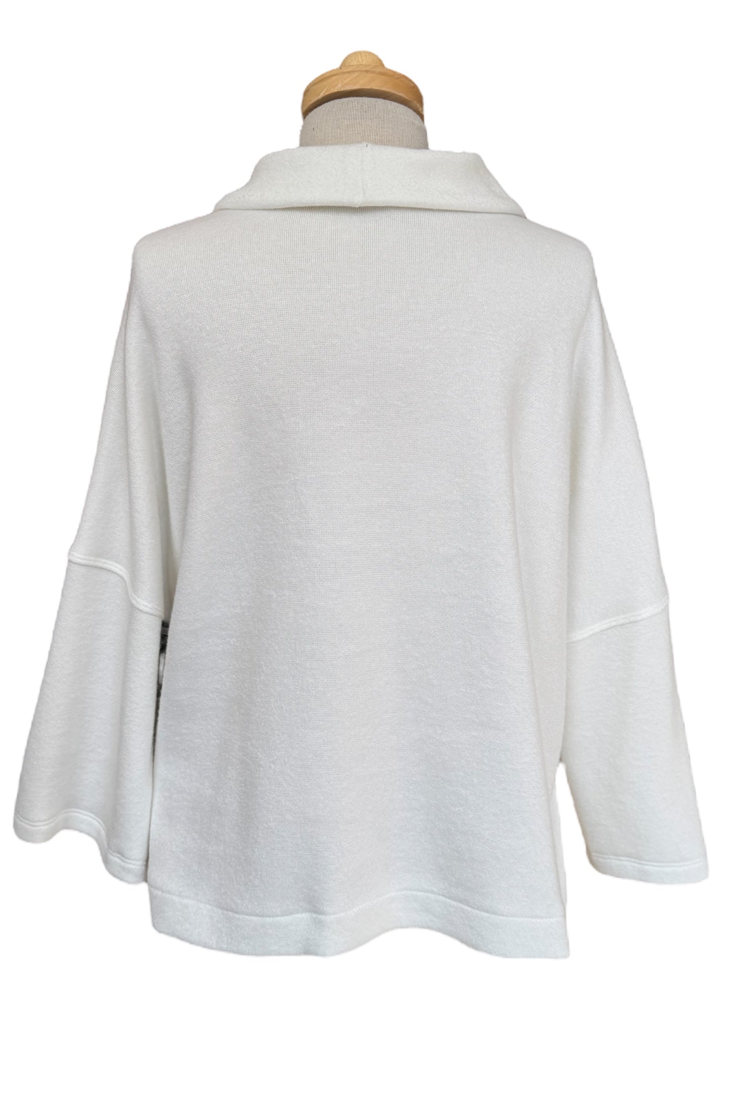 A back view of the Paige Sweater by Compli K in Off-White, featuring a large cowl neck, drop-sleeves, a loose fit, and side slits, is shown on a mannequin against a white background. 
