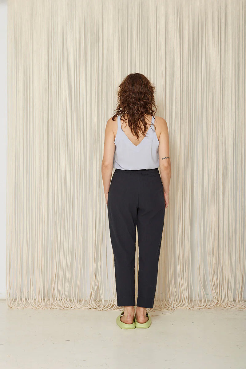 Hosta Pants by Cokluch, Black, back view, elastic waist, sewn-in belt  held in place with loops and buttons, tapered ankle-length legs, eco-fabric, cotton, OEKO-TEX certified, sizes XS to XL, made in Montreal 