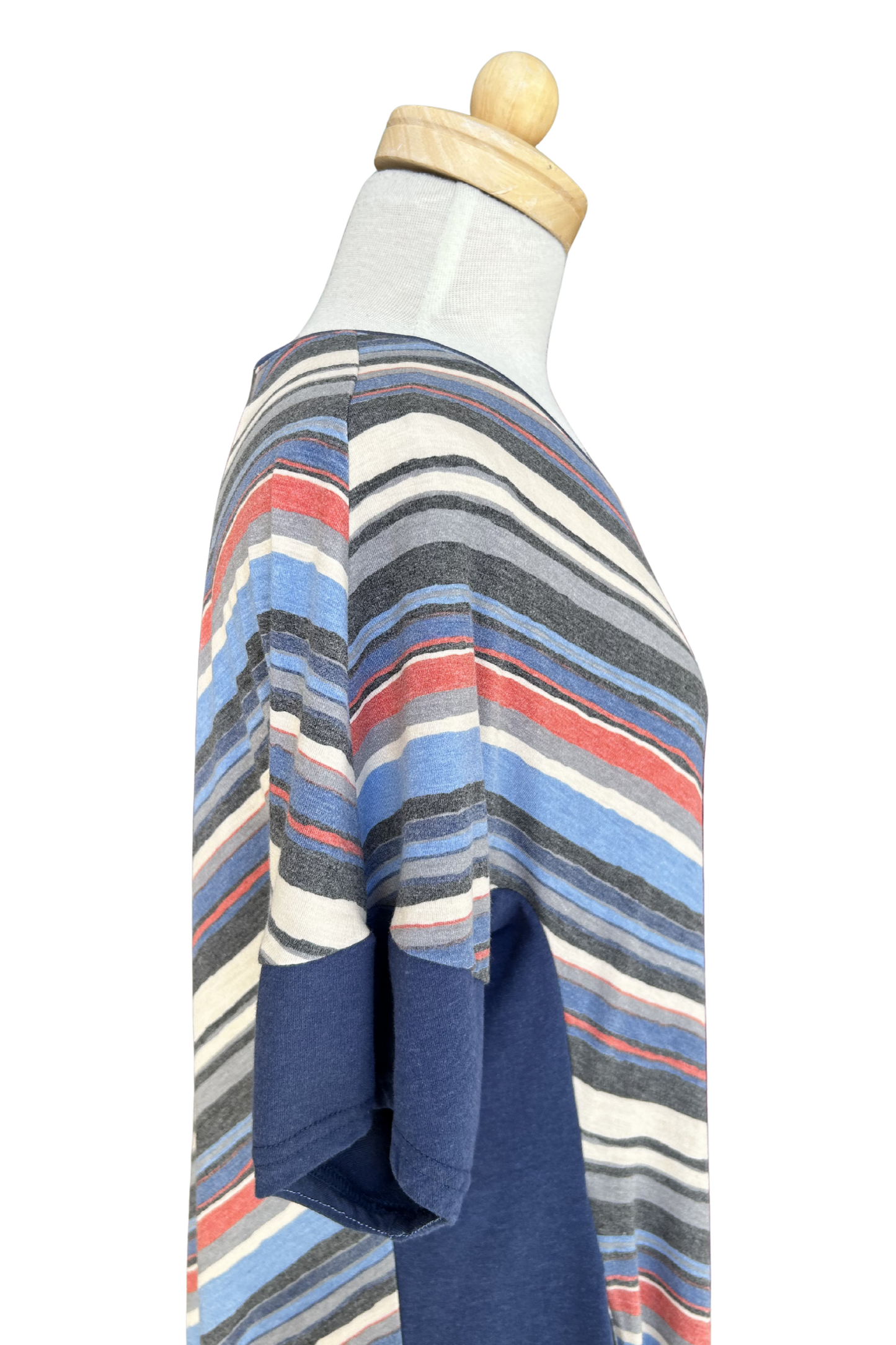 A close up side view of the Brianna Dress by Solomia is shown on a mannequin against a white background. 