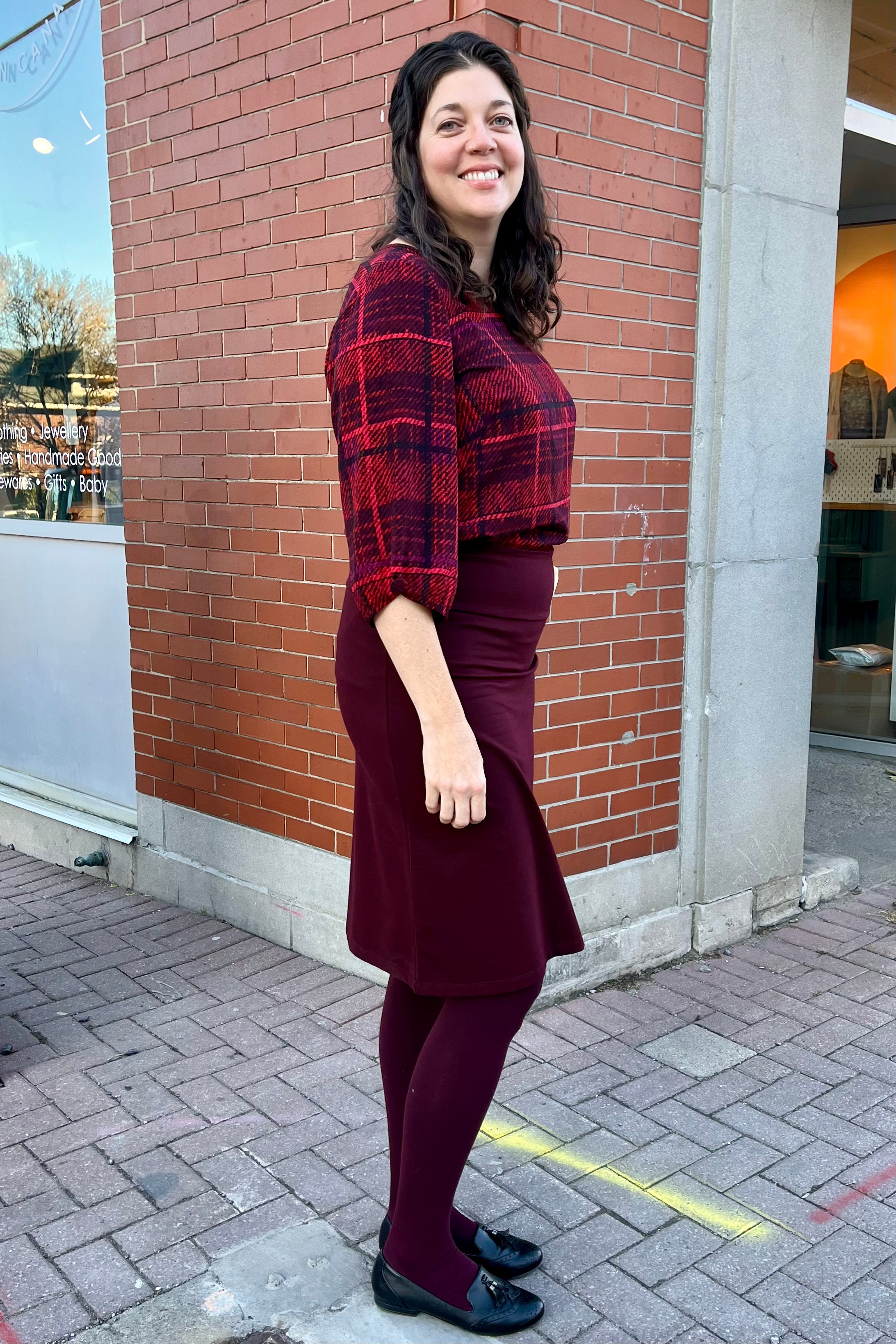 Solo Plaid Blouse by Mandala, Red, side view, wide neck, 3/4 sleeves with gathered cuff and covered button detail, back yoke, french darts, rounded hem, loose fit, sizes XS to L, made in Ontario