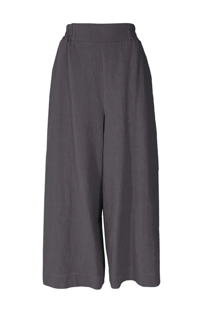 The Kurt Pants by Melow in Slate, featuring wide cropped legs, a flat-front elastic waist band, and slant pockets, are show in front of a white background. 