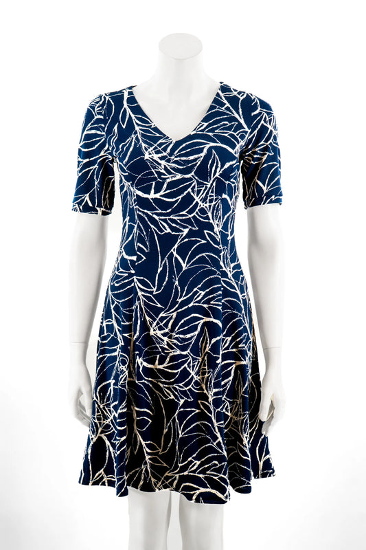 The Liana Dress by Karkass in Navy and white print, an above the knee dress with short sleeves, a V-neck and princess seams, is show on a mannequin against a white background. 