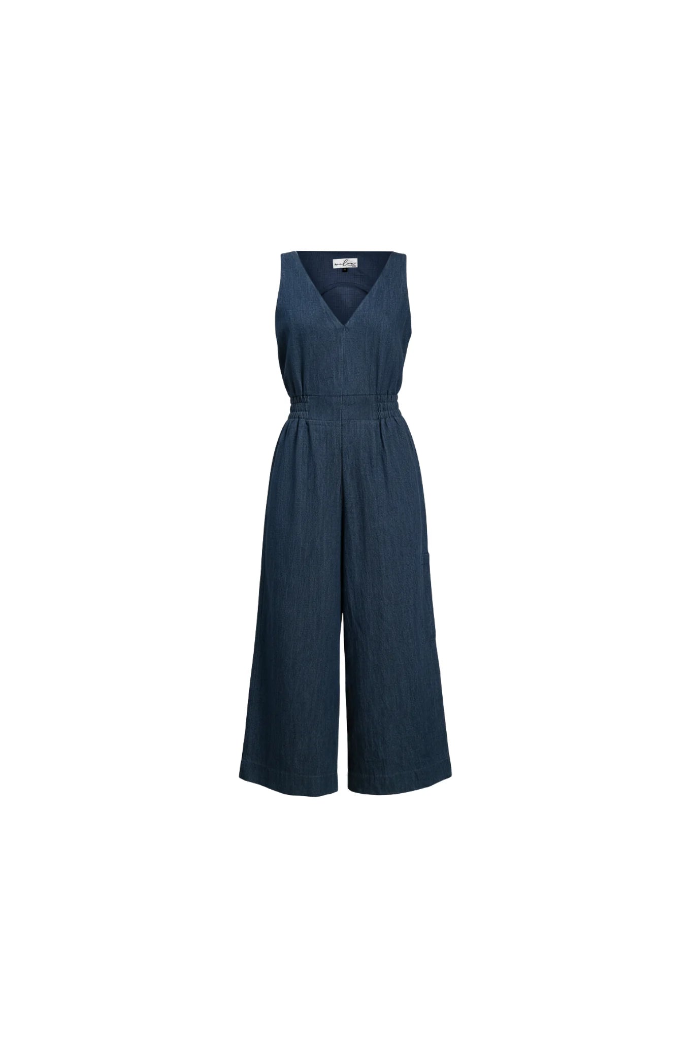 The Mathilde Jumpsuit by Melow in Denim, a sleeveless piece with a v-neck, zip front, defined waist with elastic at the sides, and wide cropped legs, is shown against a white background. 
