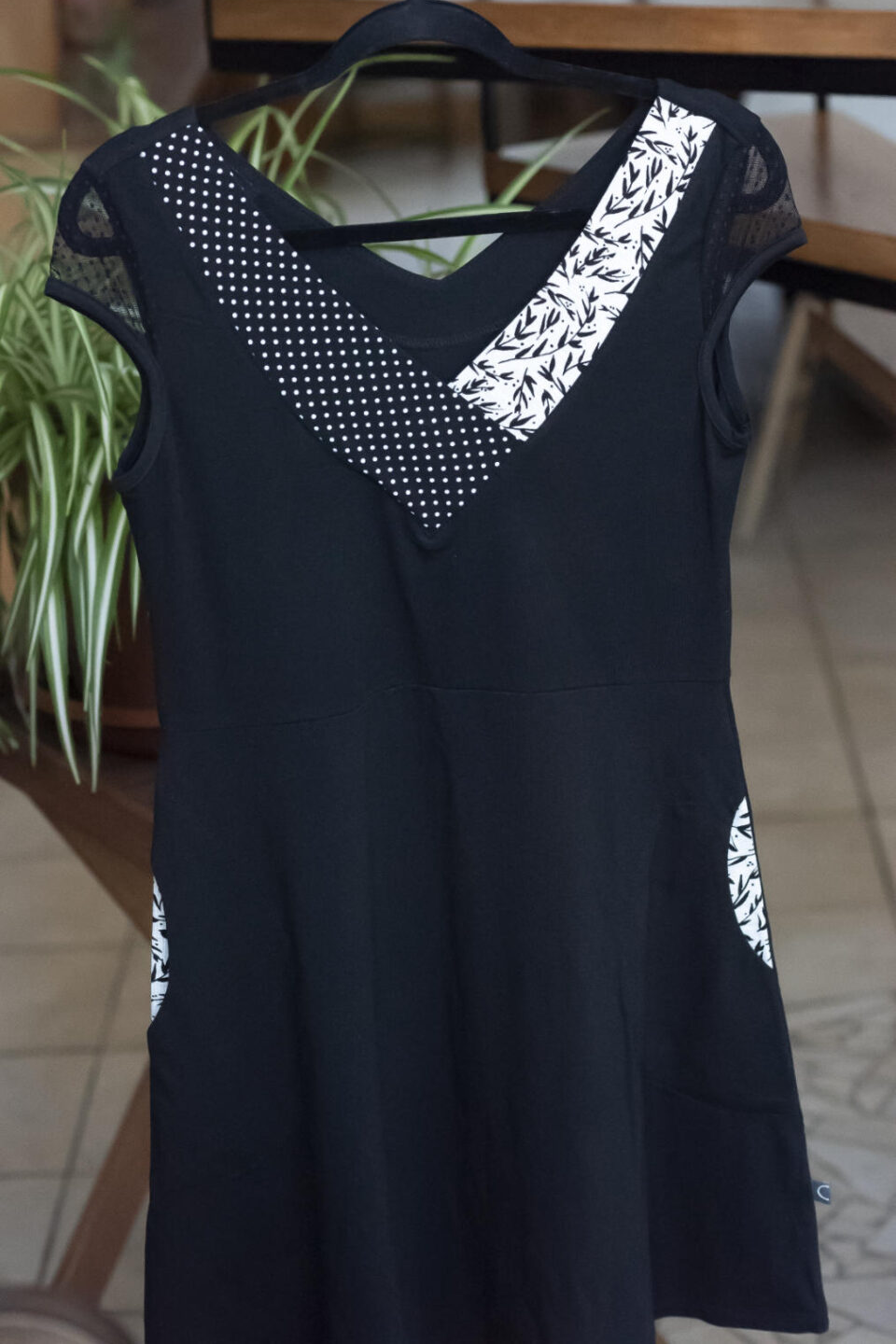 Maya Dress by Marie C, Black, V-neck, patterned fabric panels at neckline, dotted mesh cap sleeves, fit and flare shape, above the knee, pockets, eco-fabric, Tencel, organic cotton, sizes XS to XL, made in Montreal 