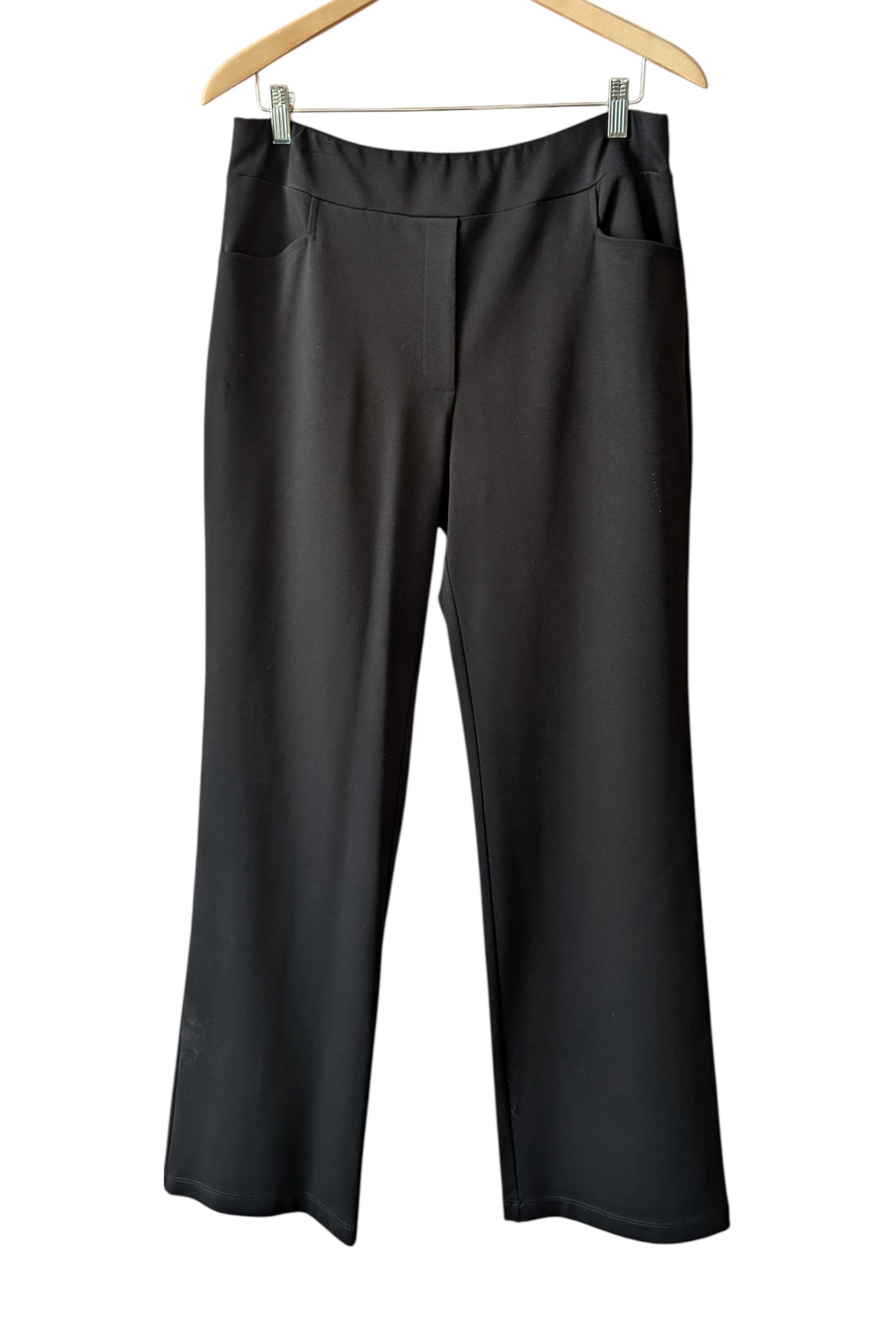 The Freddie Pants by Pure Essence in Black, pull-on pants with a wide, smooth waistband, straight legs, and front pockets, are shown hanging in front of a white background. 