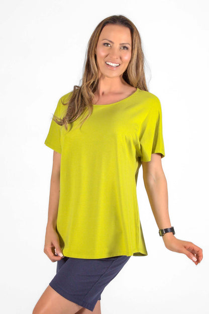 Woman wearing the Callie Top by Pure Essence in Black, a basic t-shirt, standing in front of a white background