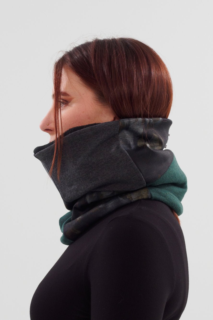 Side view of woman wearing the Slak A24 Neck Warmer in Grey, made of contrasting scraps of fabric from the current collection and lined with polar fleece.