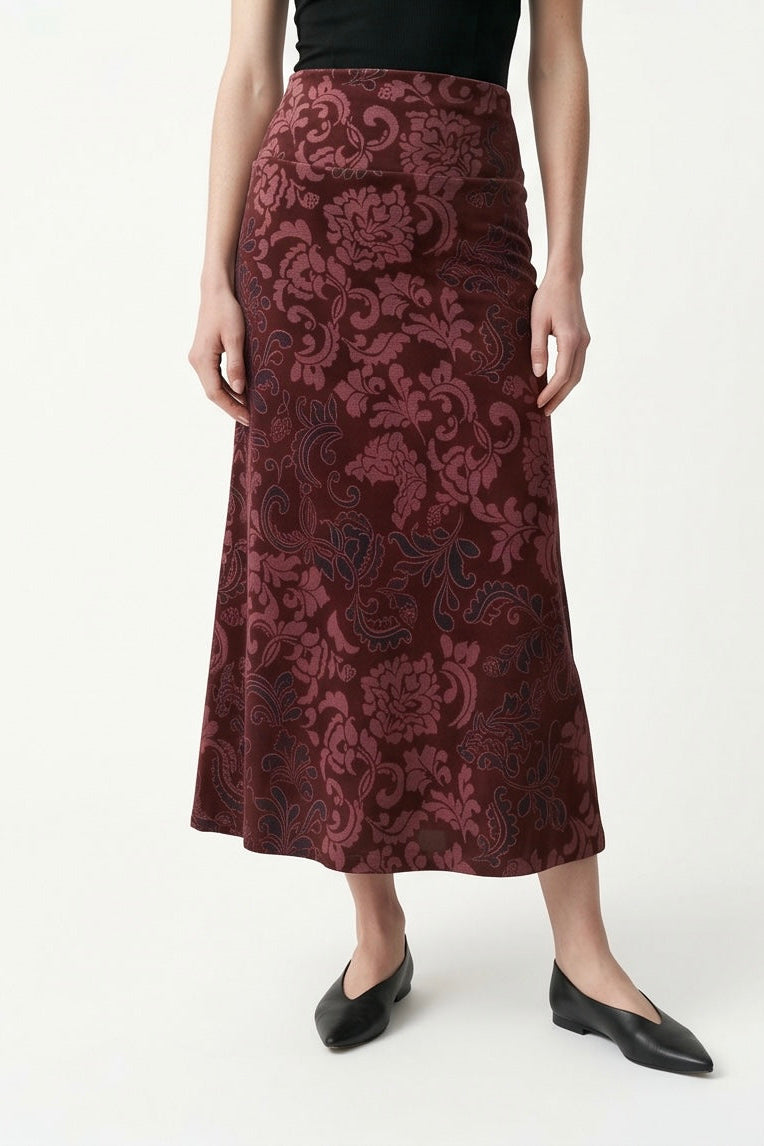 The Kollontai Winslet skirt, a burgundy velvet midi skirt, is shown on a mannequin against a white background. 