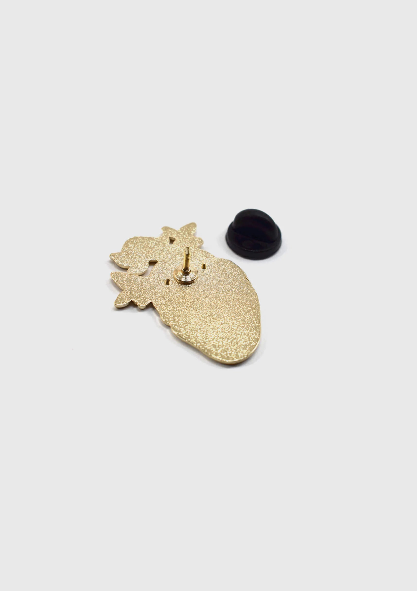 A back view of the Heart Flower Pin by Badaboöm Studio is shown against a white background. 