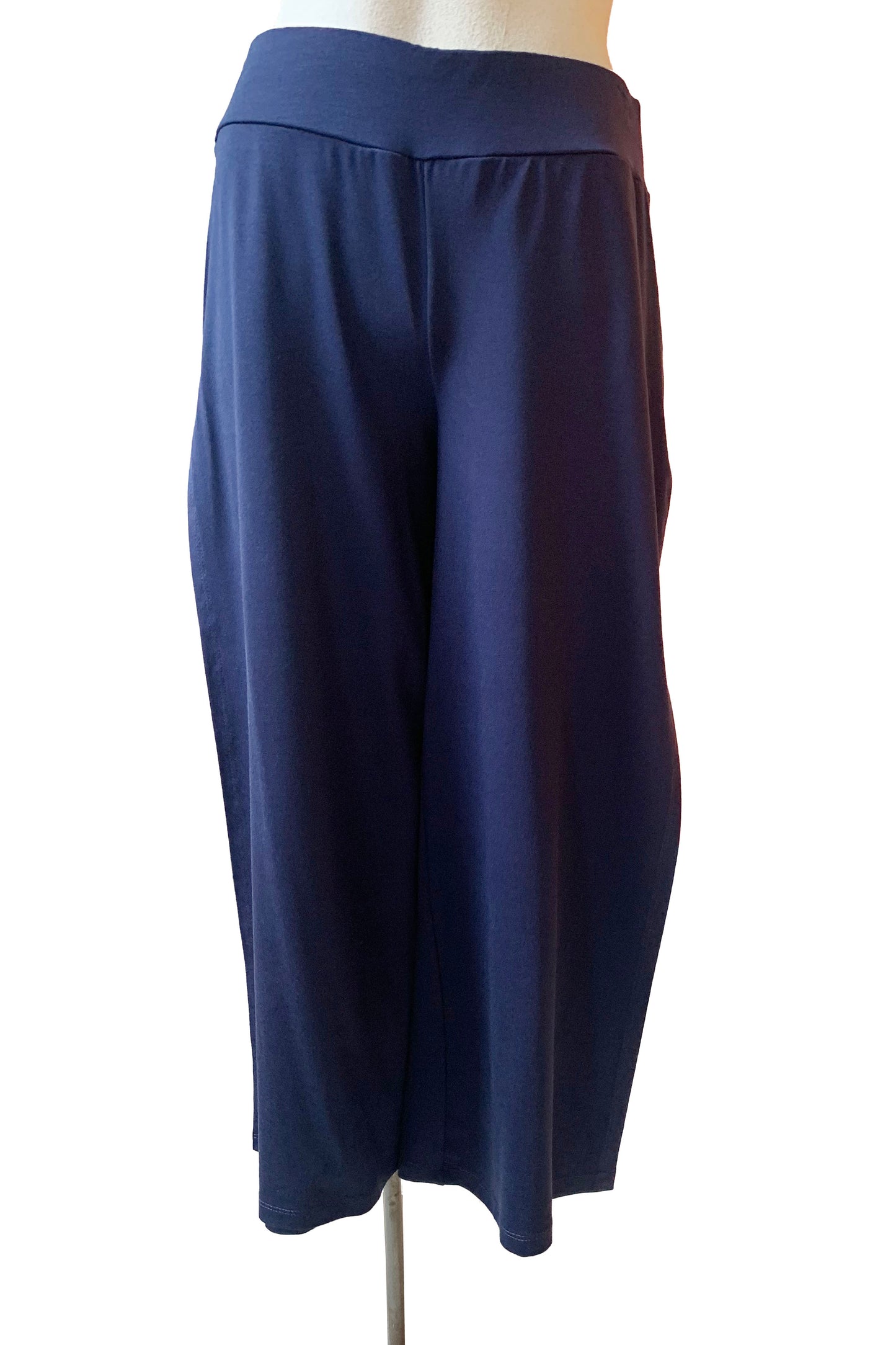 The Colin Capri Pants in Navy by Pure Essence are shown on a mannequin in front of a white background