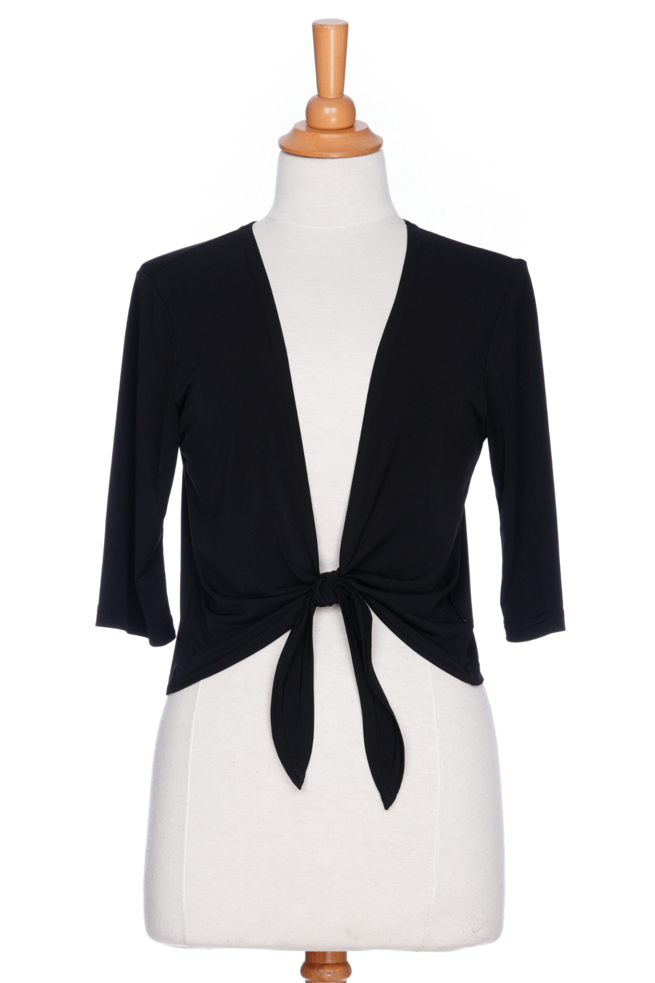 The Petillant Bolero by Rien ne se Perd in Black, with 3/4 sleeves and a tie front, is shown on a mannequin against a white background. 