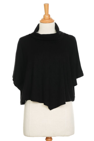 The Delacroix Bolero-Poncho by Rien ne se Perd in Black is show on a mannequin front of a white background