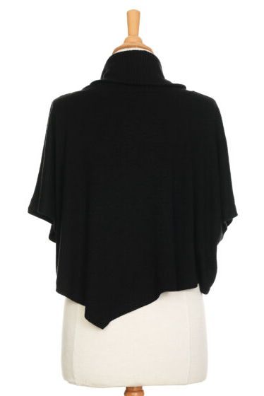 A back view of The Delacroix Bolero-Poncho by Rien ne se Perd in Black is show on a mannequin front of a white background