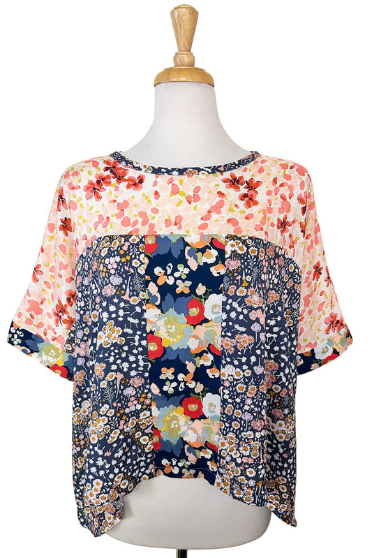 The Chloe Top by Desserts and Skirts in Floral Strip is shown on a mannequin with a white background