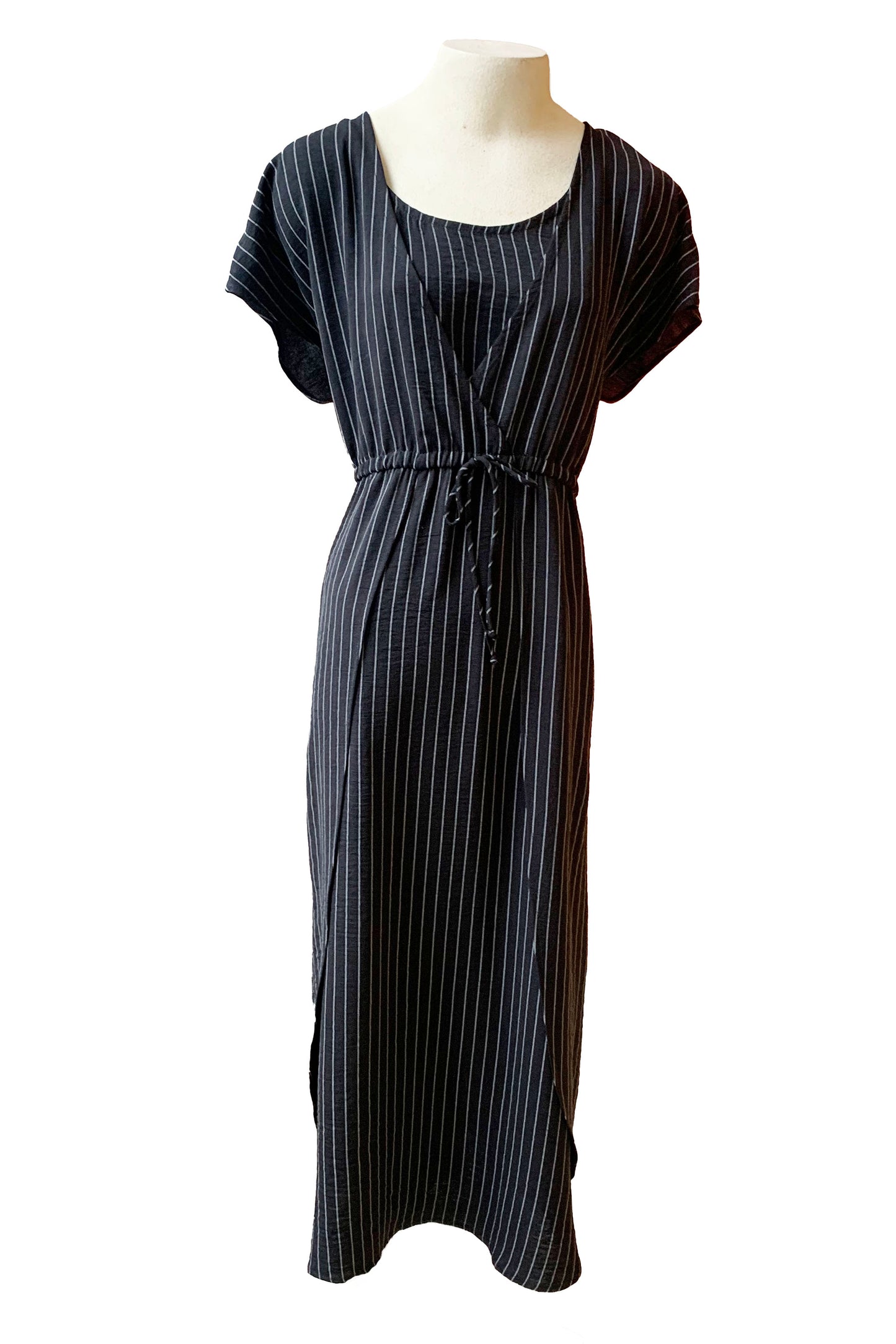 The Clementine Dress by Pure Essence in Black pinstripe is shown on a mannequin in front of a white background