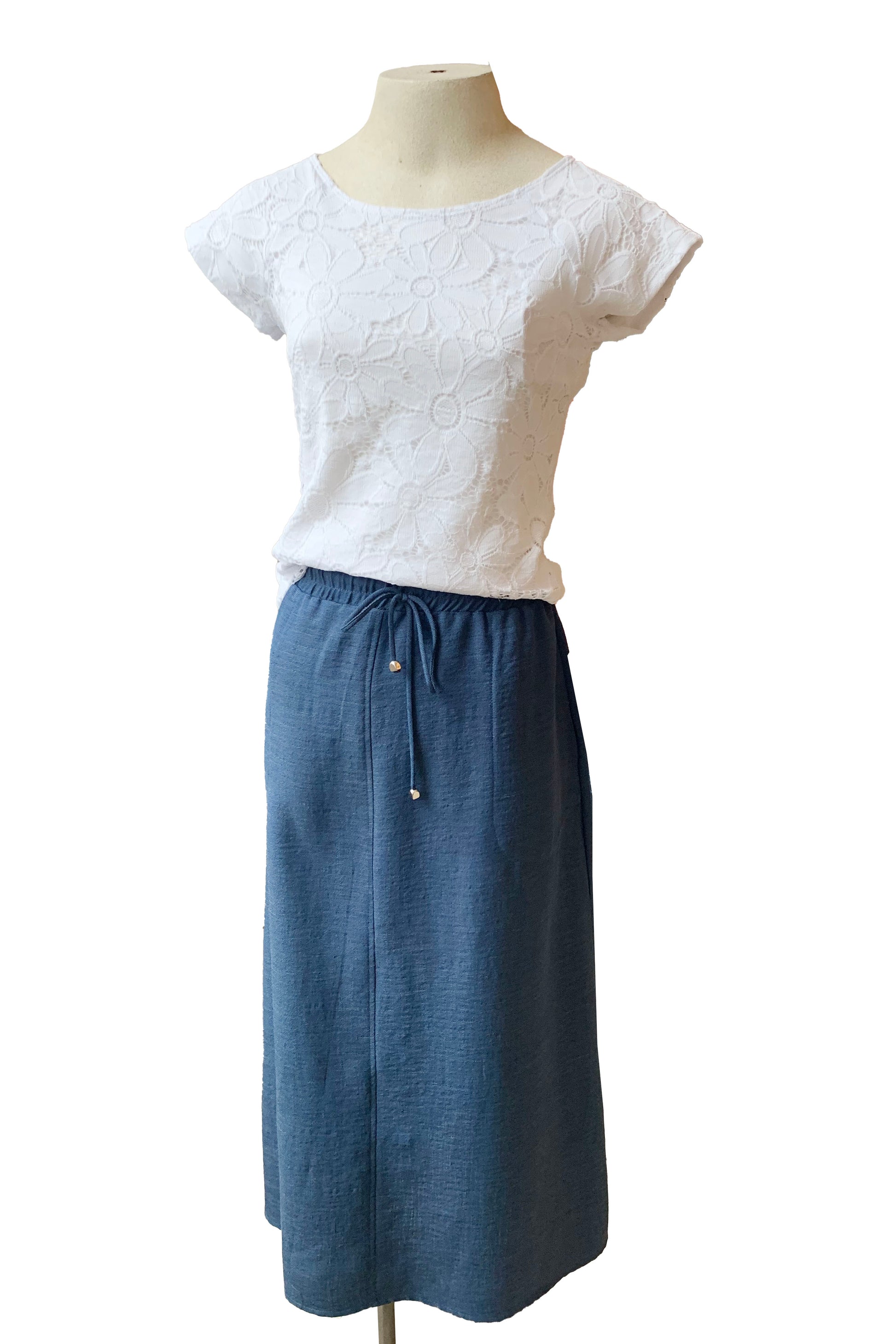 The Cole Skirt in Indigo by Pure Essence is shown with the Lily Top by Luc Fontaine on a mannequin in front of a white background