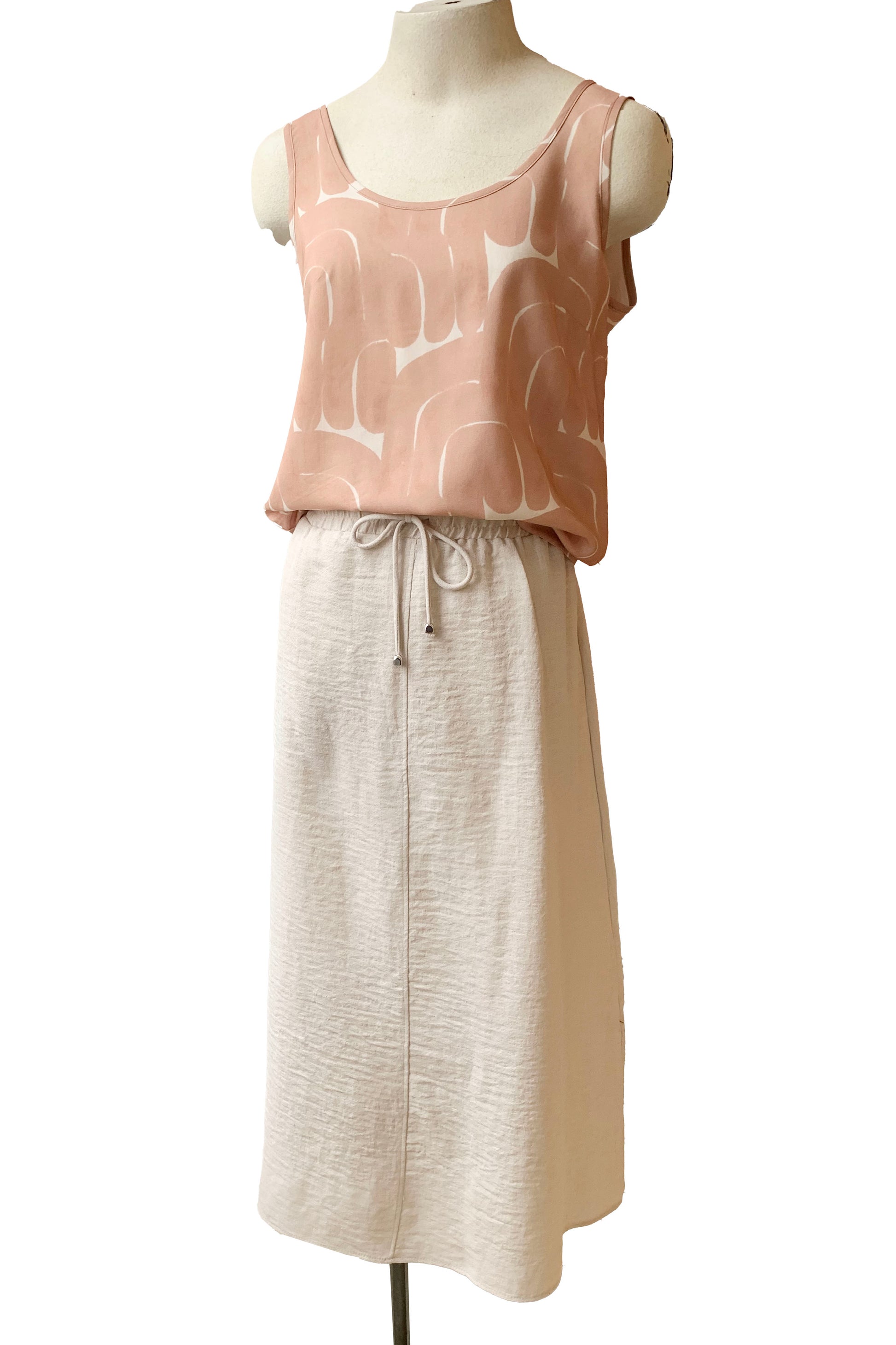 The Cole Skirt in Sand by Pure Essence is shown with the Isatis Top by Cokluch on a mannequin in front of a white background 