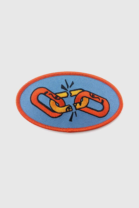 Embroidered  Weakest Link patch from Badaboöm Studio, with a design of two multicoloured chain links on a blue background, bordered by orange