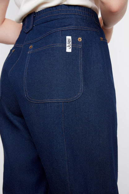 Close up of the back waist and leg of the A woman wearing the Alice Straight Leg Jeans by Julei in Dark Denim.