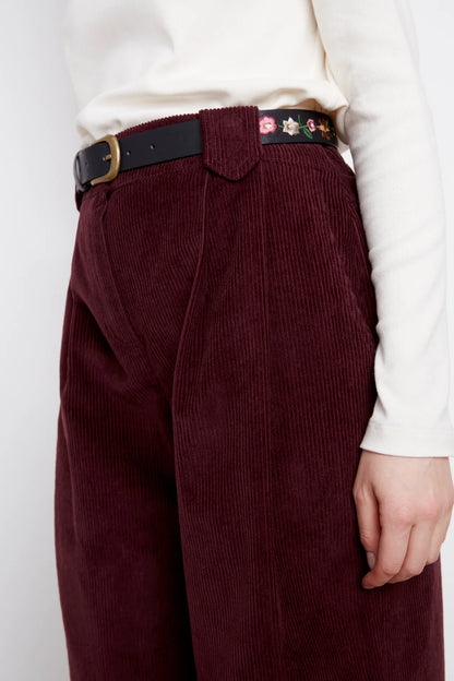 Close up of the waist and legs of the Idadora Pants by Julei in Bordeaux, wide-leg corduroy pants.