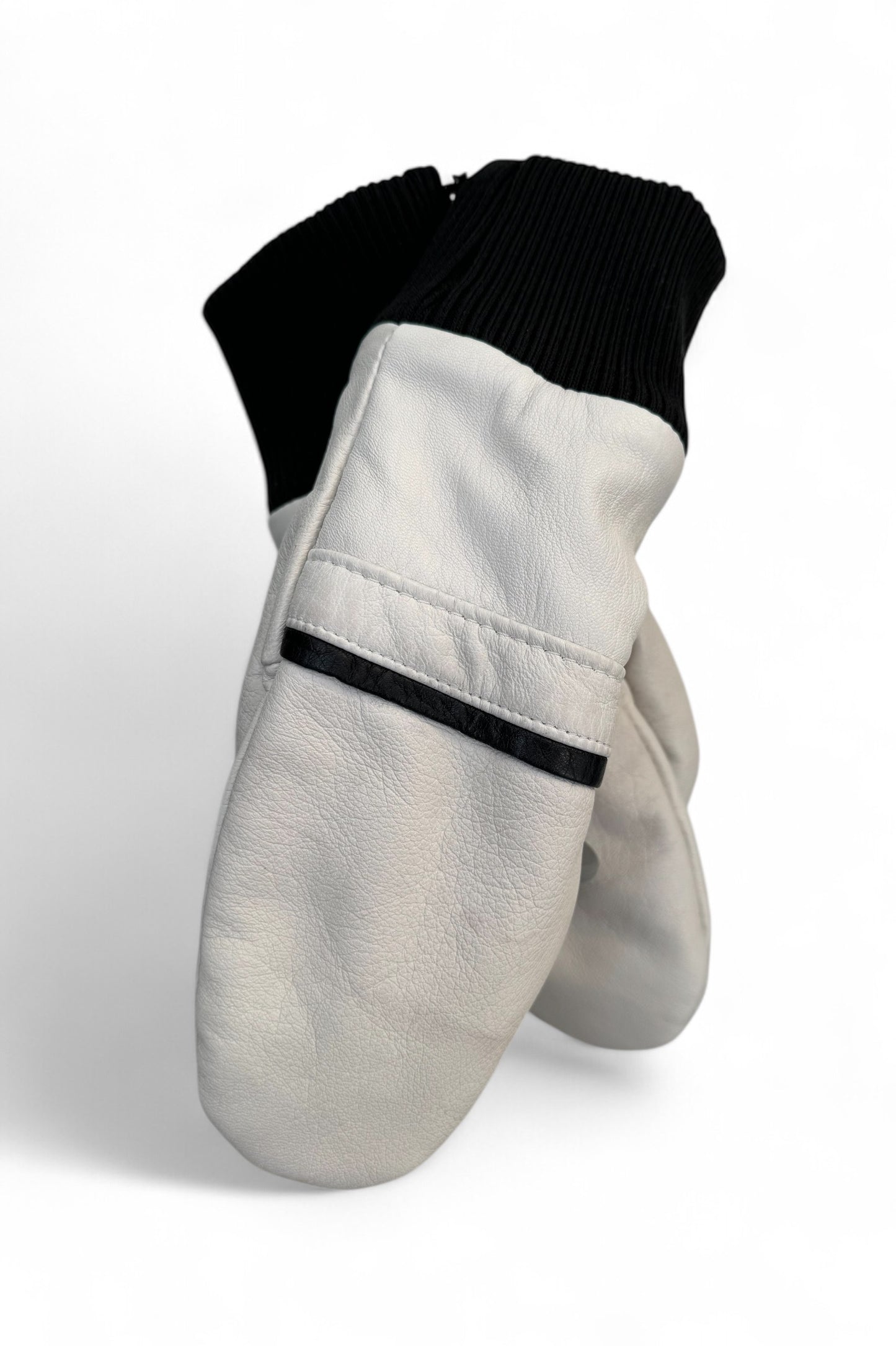 Lhasa Mittens by Kazak in White, featuring recycled leather, black ribbed knit cuffs, and fleece lining. 