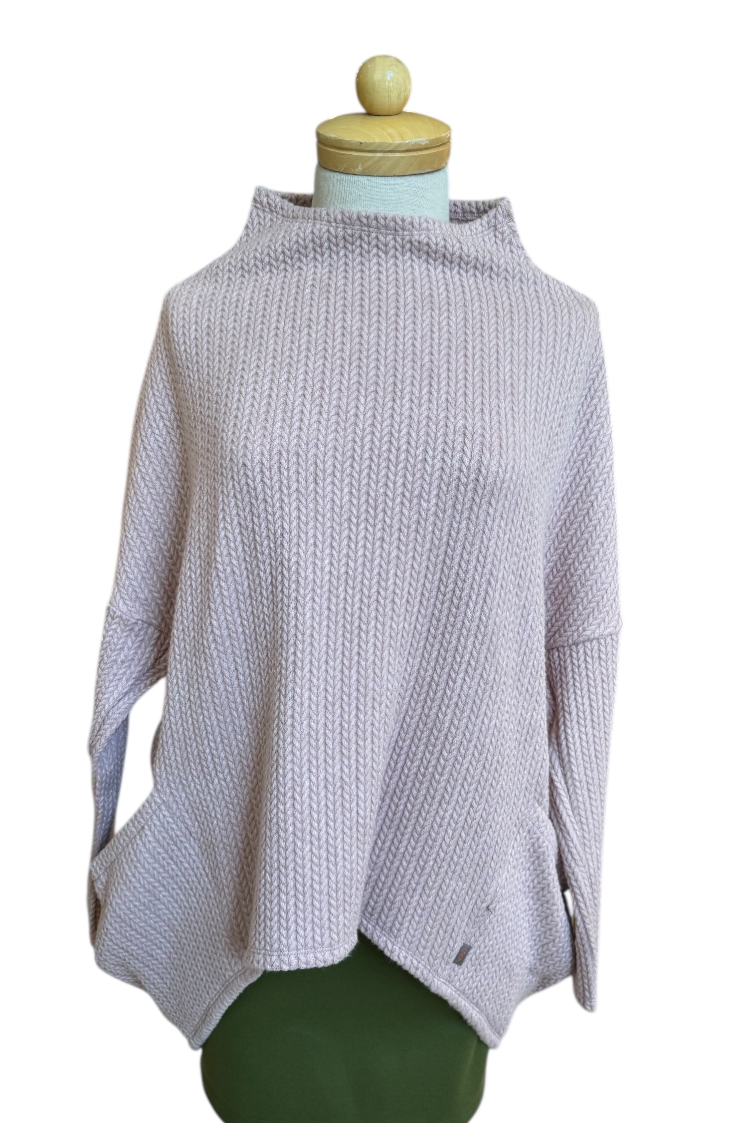 The Meeso Sweater by MOOVment in Lilac, a One Size oversized knit sweater with a wide mock turtleneck, long dropped sleeves and large side pockets, is shown on a mannequin in front of white background. 
