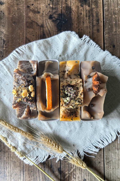 Overhead view of bars of Stay Wild Apothecary soap on a wooden table 