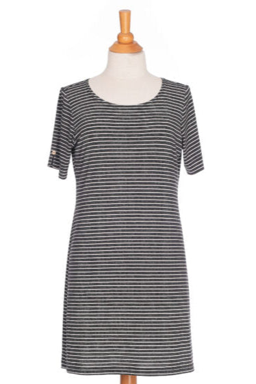 The Boogie Dress by Rien ne se Perd in Grey/White Stripe, a t-shirt dress with a wide neck, side pocket, and slit and coconut button detail on the short sleeves, is shown on a mannequin in front of a white background. 