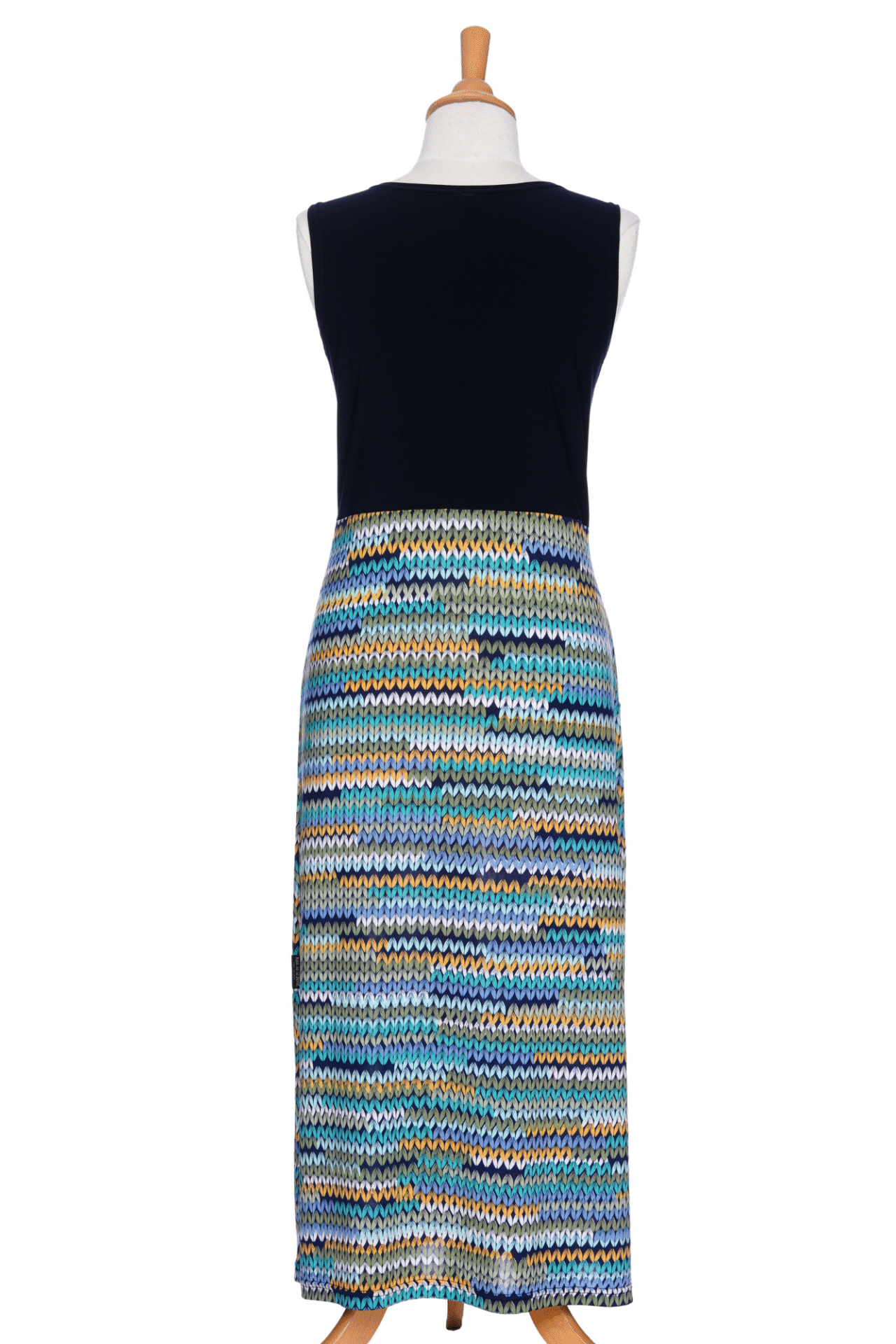 A back view of the Mimosa Dress by Rien ne se Perd in Navy/Mesh print, a sleeveless 7/8 length dress with a solid navy top and a straight skirt with a mesh print in blue tones, is shown on a mannequin against a white background. 