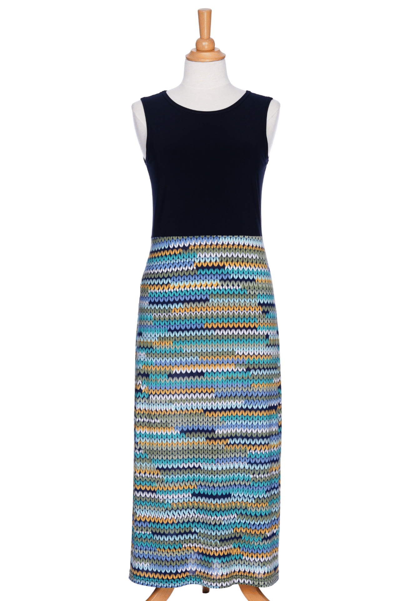 The Mimosa Dress by Rien ne se Perd in Navy/Mesh print, a sleeveless 7/8 length dress with a solid navy top and a straight skirt with a mesh print in blue tones, is shown on a mannequin against a white background. 
