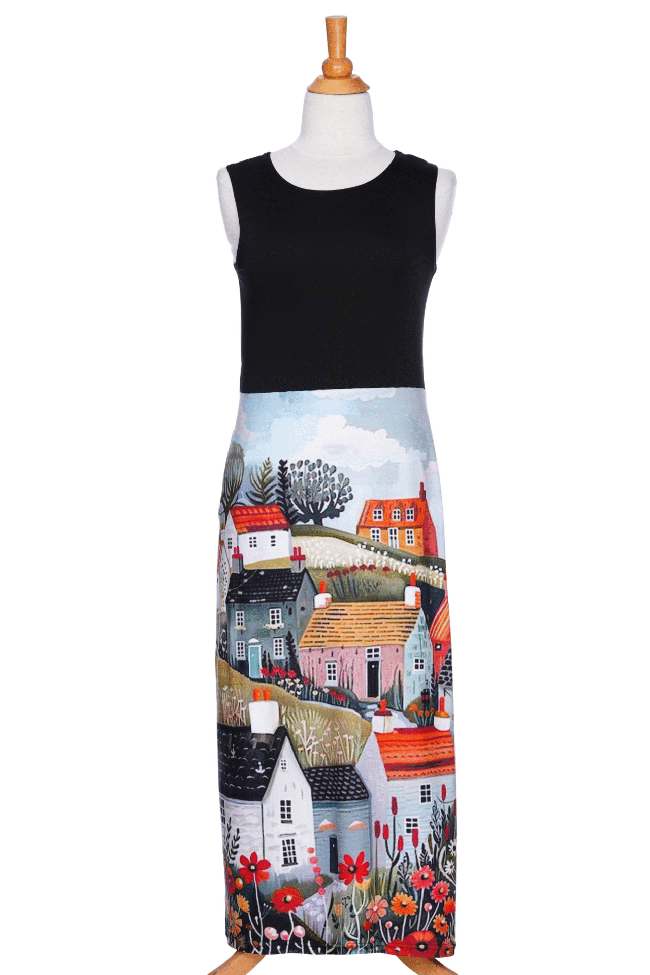 The Mimosa Dress by Rien ne se Perd in Black/Landscape print, a sleeveless 7/8 length dress with a solid black top and a straight skirt with a print of houses and flowers, is shown on a mannequin against a white background. 