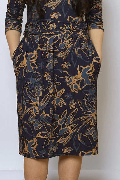 Waist-down close up view of a woman wearing the Cascade Dress by Tangente in Navy Print. 