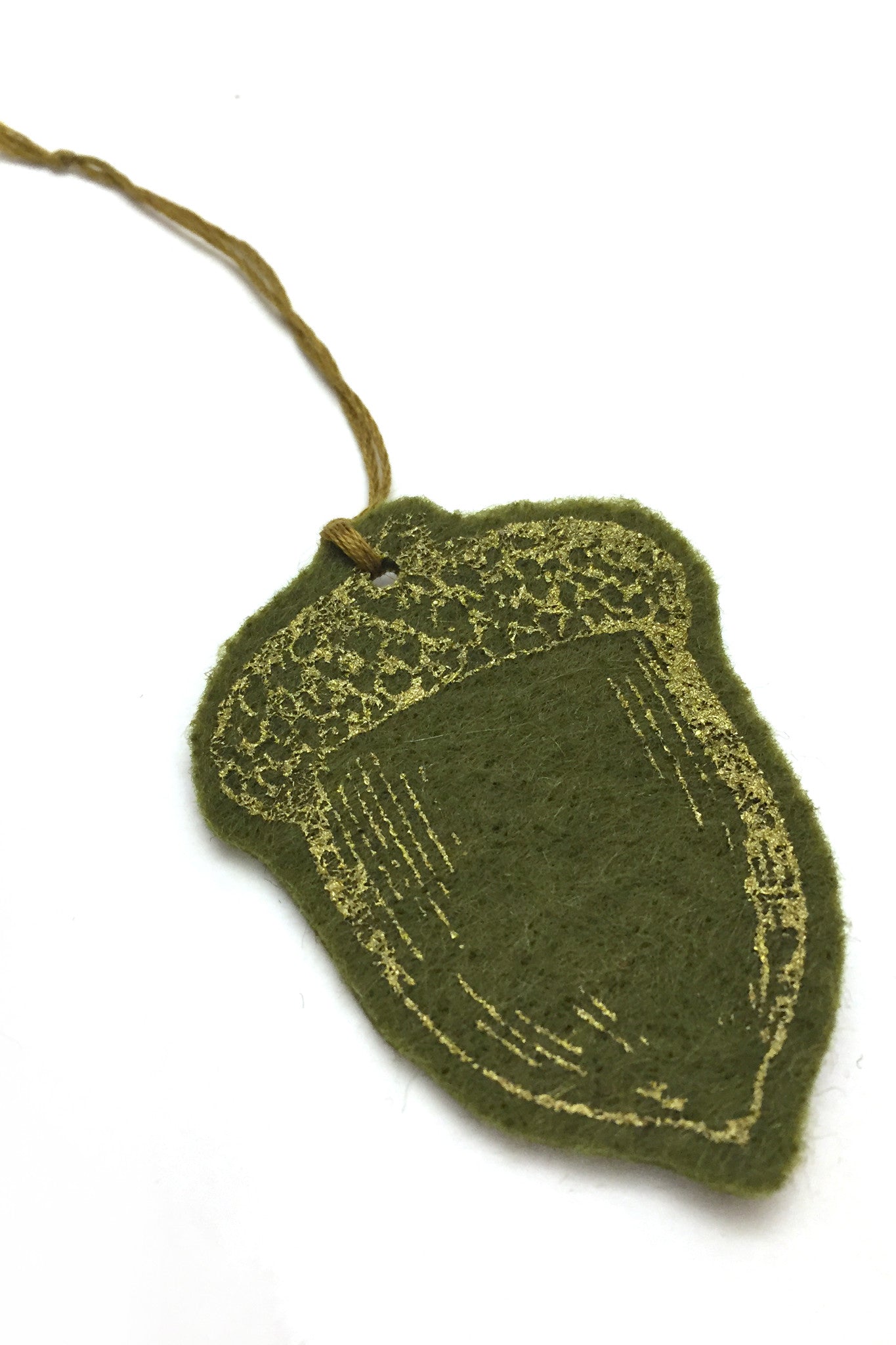 Workshop studio green and gold handprinted and cut acorn ornament detail. Handmade in Ottwa