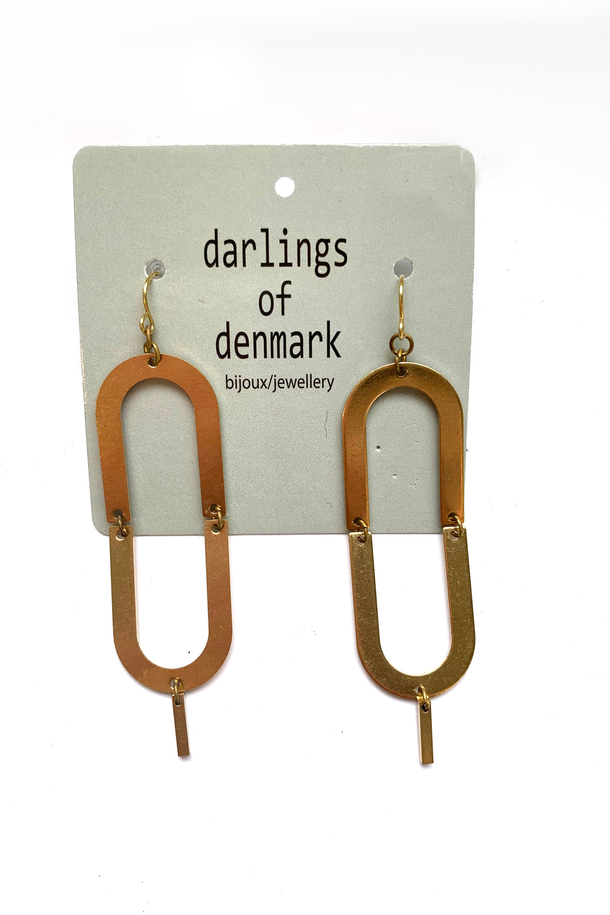 Geepe dangle earrings by Darlings of Denmark; raw brass; double arch with a short hanging stick; flat lay