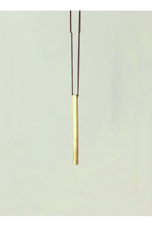 Slik necklace by Darlings of Denmark; raw brass; long solid bar; long chain; close-up shot